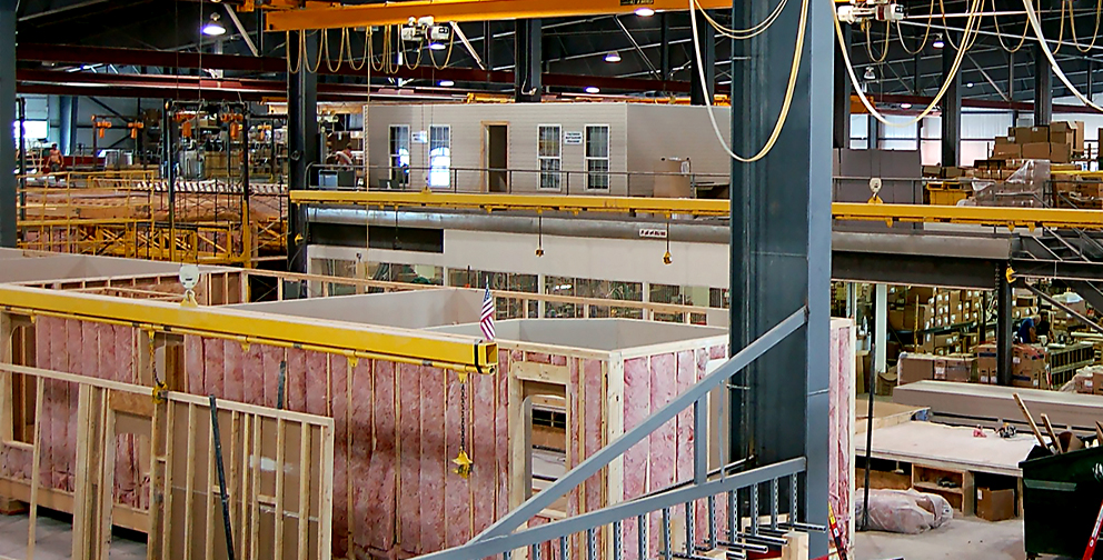 Modular buildings being constructed in a factory