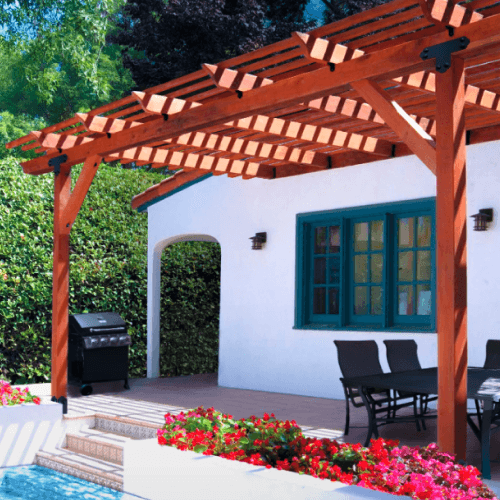 Wood patio cover attached to house providing shade.