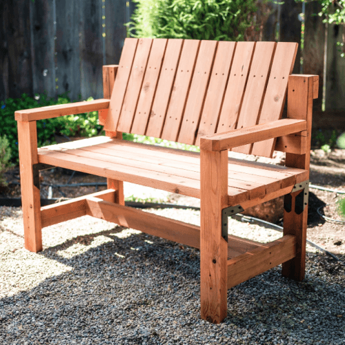Sun shining on wood garden bench.