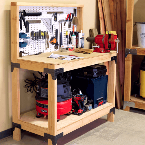 Tools nicely organized on a heavy duty wood workbench in a garage.
