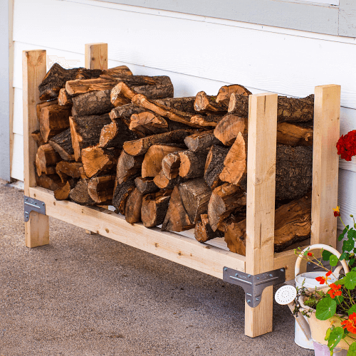 Logs for a fire pit stored on a homemade log holder.