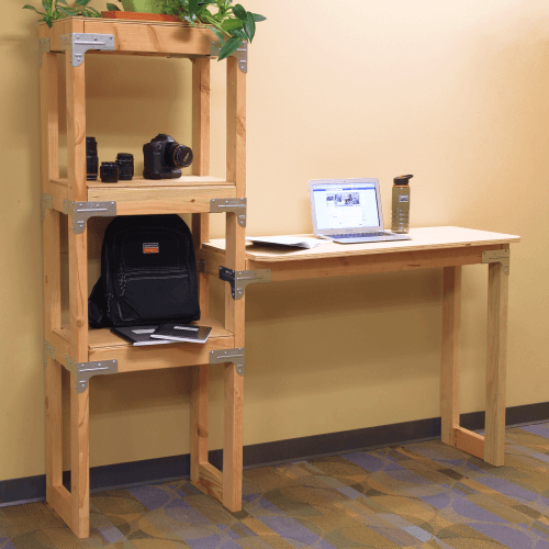Wood shelves attached to standing desk with a laptop.