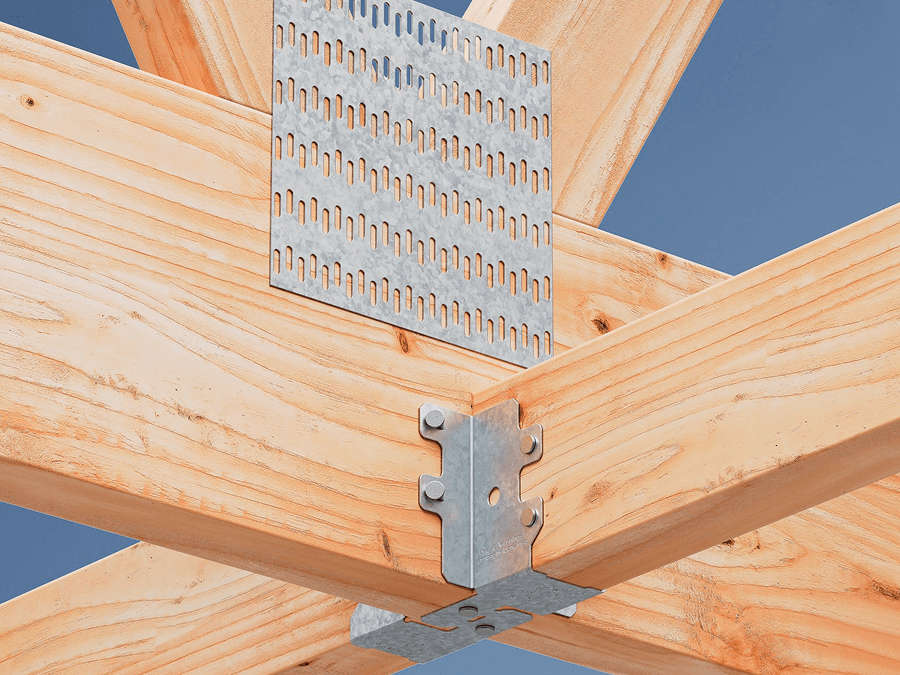 Close-up of wood beams joined with galvanized steel connectors and a perforated plate against a clear blue sky, showing structural hardware for framing.