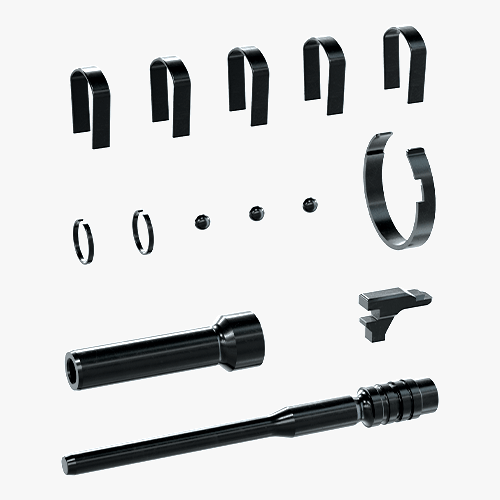 Collection of black steel replacement parts for powder-actuated tools, including piston, springs, and fastener retainers.