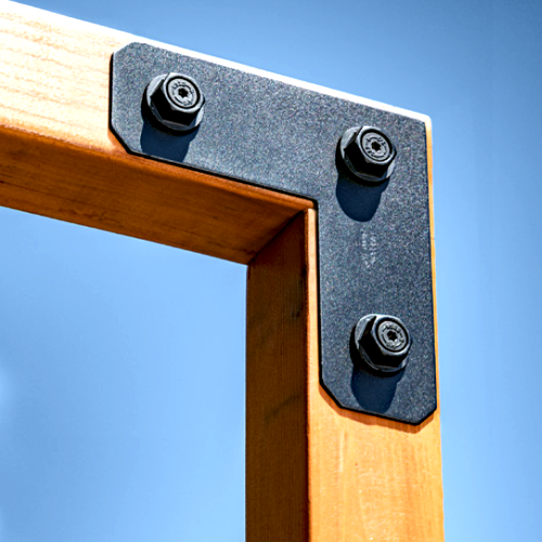 APVL4 L strap tie tie with black bolts connecting two wooden beams at a right angle.