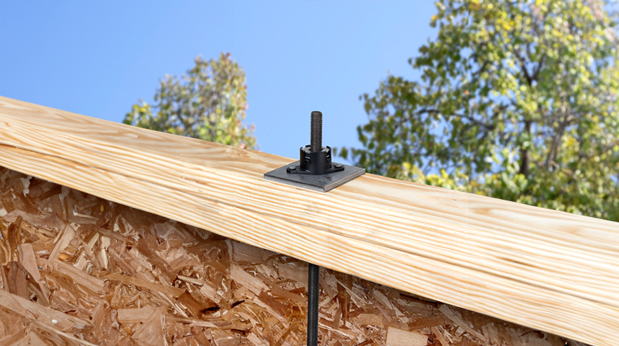 Example of uplift restraint system installed within two wooden beams.