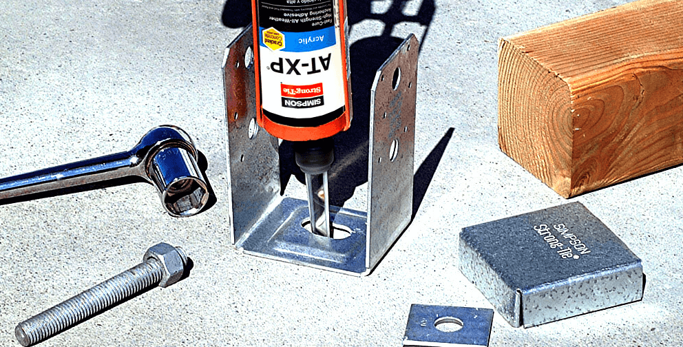 Simpson Strong-Tie AT-XP adhesive anchor system being applied to a metal base bracket, with accompanying bolt, wrench, and wooden beam.