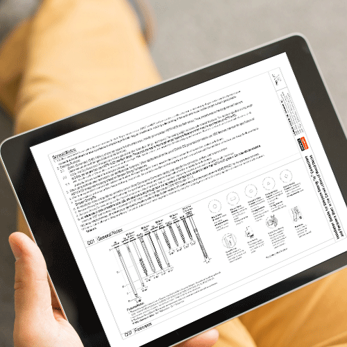 A man holding an iPad and viewing deck product installation drawings.