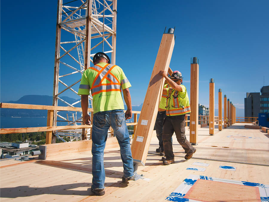 Construction workers installing mass timber solution.