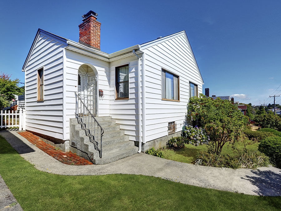 Older single story home with white siding.