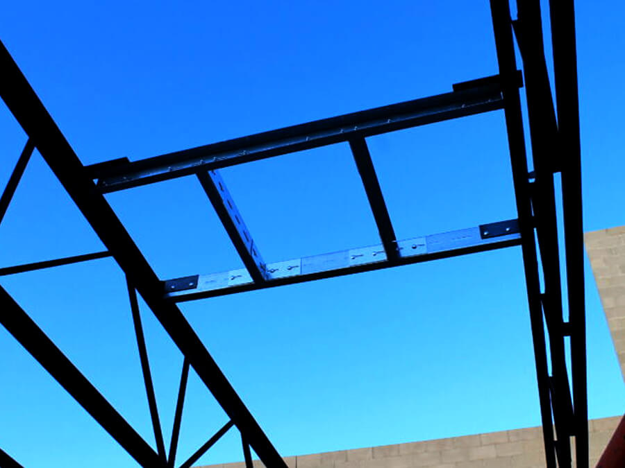 A QuickFrames steel support system installed on a rooftop structure, providing reinforcement for future HVAC or mechanical equipment installation against a clear blue sky.