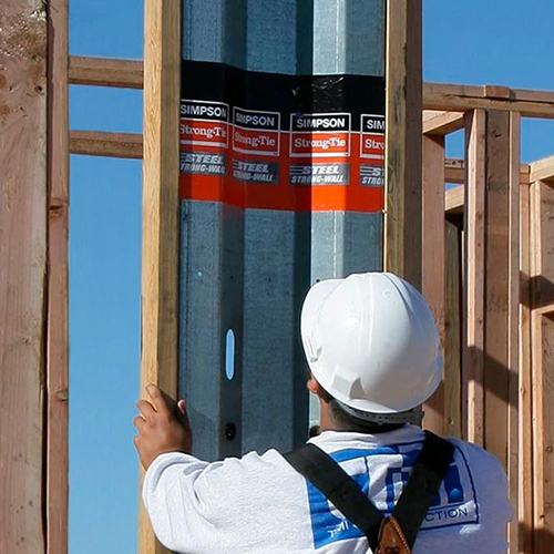 Construction worker setting up Strongwall Shearwall product at a construction site.