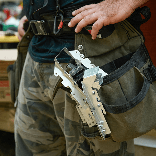 A worker with LUS28Z Hangers tucked in his tool belt bag